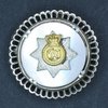 Mother of pearl and silver brooch. This pattern of brooch was created for the wives of members of the 3rd Battalion when the Canadian Fusiliers and Oxford Rifles were amalagamated to form the Reserve Battalion of The RCR in 1954.