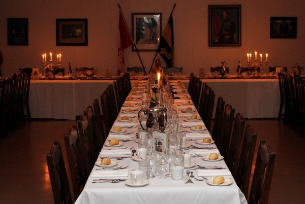 A Mess Dinner table including regimental silver trophies, flags and menus.